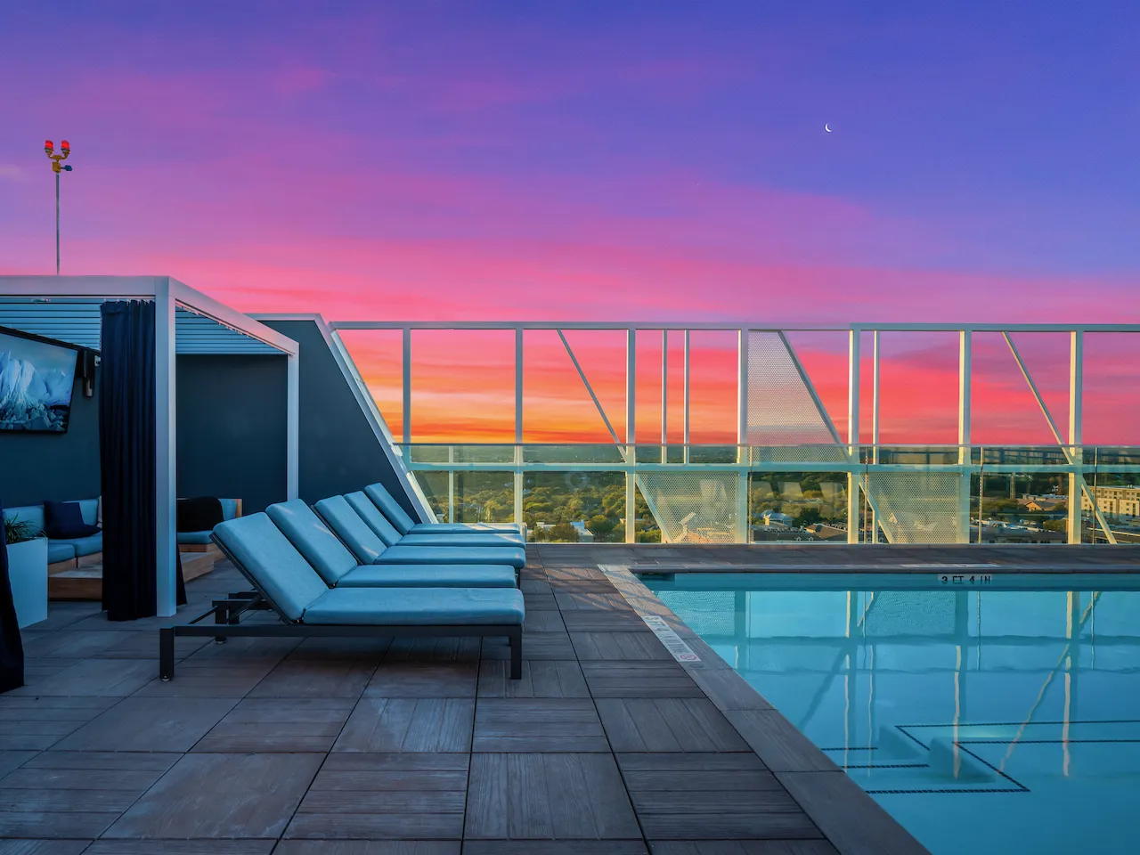 rooftop pool with pergola seating and view of horizon